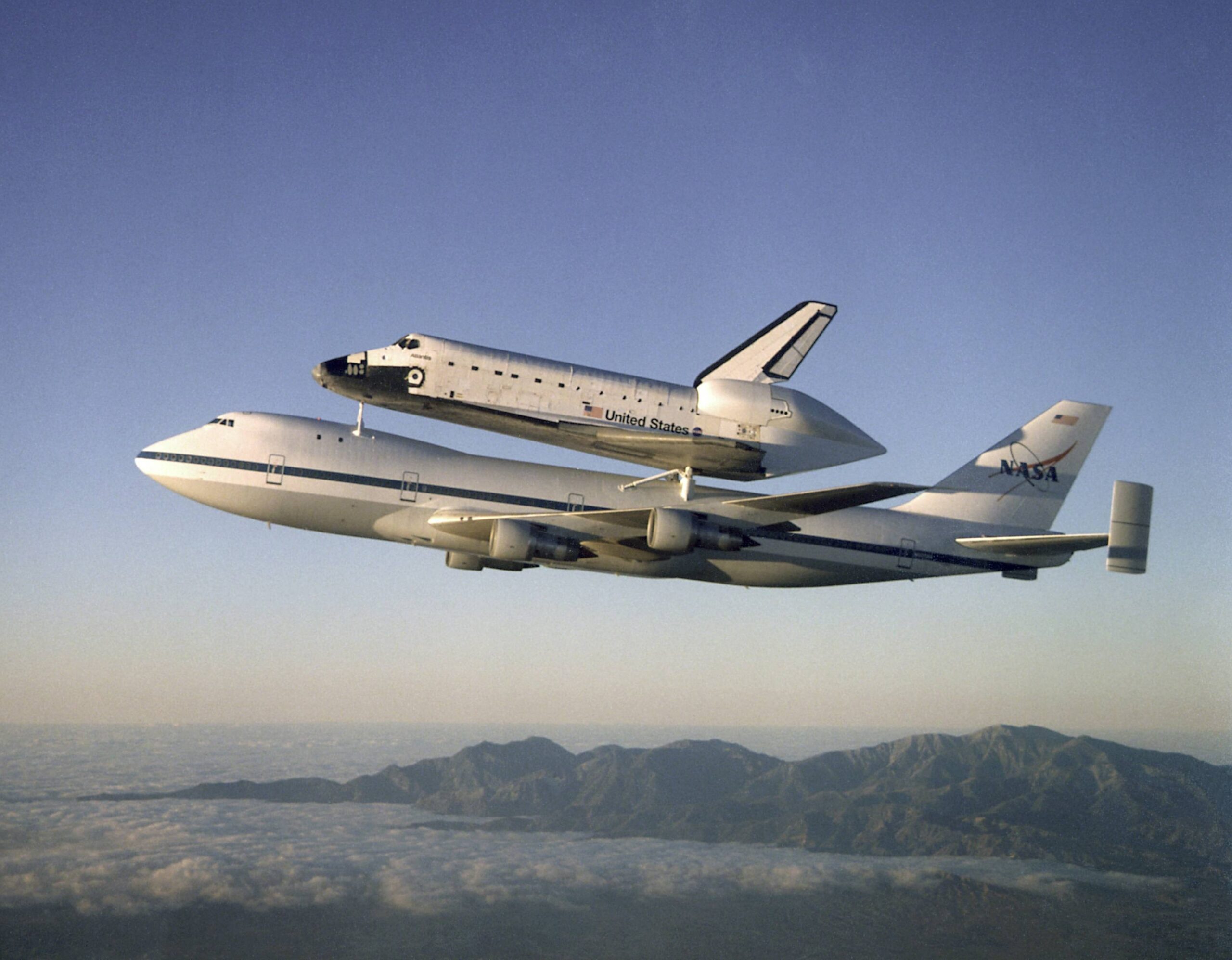 How does the Space Shuttle attach to the Boeing 747 during transport?